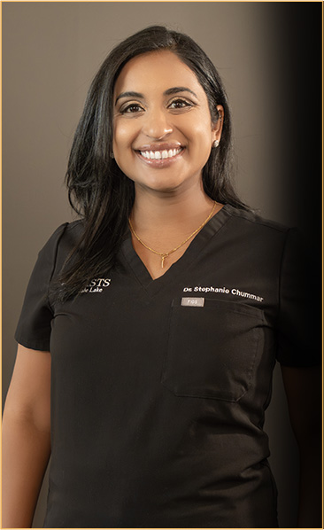 Portrait of Dr. Stephanie Chummar, a compassionate dentist at Dentists of Hinsdale Lake, with a DDS from New York University, smiling in her clinic attire, reflecting her patient-centric approach and expertise in prosthodontics and smile makeovers.