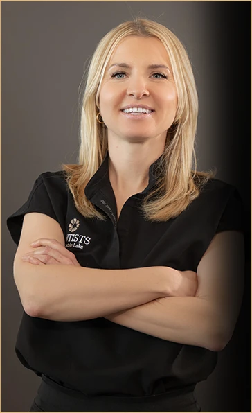 Portrait of Basia, an award-winning dental hygienist with a Bachelor's in teaching, confidently posed in her Dentists of Hinsdale Lake uniform, her approachable smile reflecting her dedication to patient care and building personal connections.