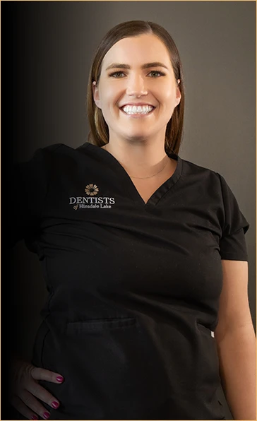 Portrait of Katie, a skilled dental hygienist at Dentists of Hinsdale Lake, recognized with the Hu-Friedy Golden Scaler and Colgate STAR awards, smiling broadly in her black clinic uniform, embodying the clinic's dedication to patient confidence and oral health.