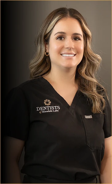 Professional portrait of Valentina, an award-winning dental hygienist at Dentists of Hinsdale Lake, wearing a clinic uniform with a warm and welcoming smile, embodying the firm's commitment to top-tier dental care and patient education.